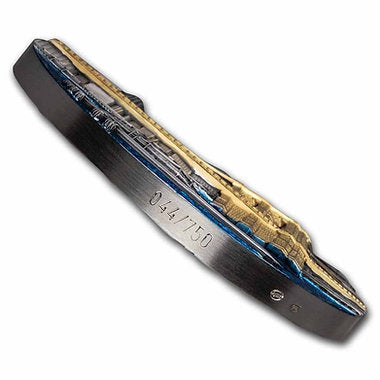 Close-up of a pocket knife blade with engraved text on a white background