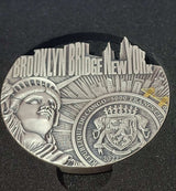 Silver coin with Brooklyn Bridge design on a dark background