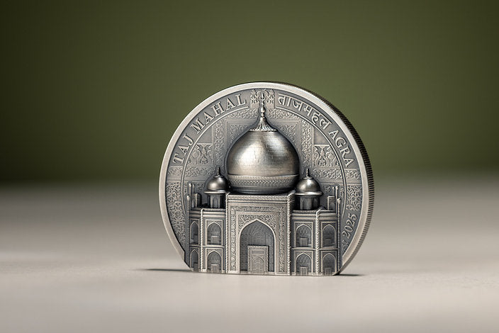 Taj Mahal silver coin standing upright at a slight angle, showing the sculpted dome, ornate façade and right-hand reeded edge.