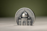 Taj Mahal silver coin standing upright at a slight angle, showing the sculpted dome, ornate façade and right-hand reeded edge.