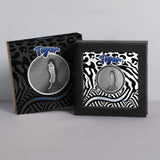 Tiger Camouflage of Nature silver coin in a black presentation stand beside its tiger-patterned outer packaging.