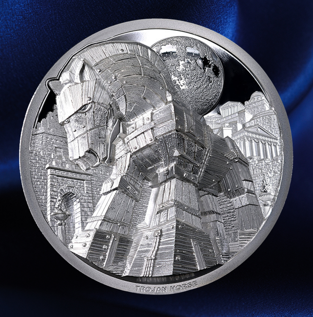 A circular silver-toned coin or medallion featuring a detailed relief of the Trojan Horse, with a textured globe behind it, set against a dark blue satin-like background.