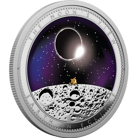 A round silver-toned commemorative coin featuring an eclipse scene on the moon, with the text 'THE MOON'S VIEW' and 'EARTH IN ECLIPSE' around the edge.