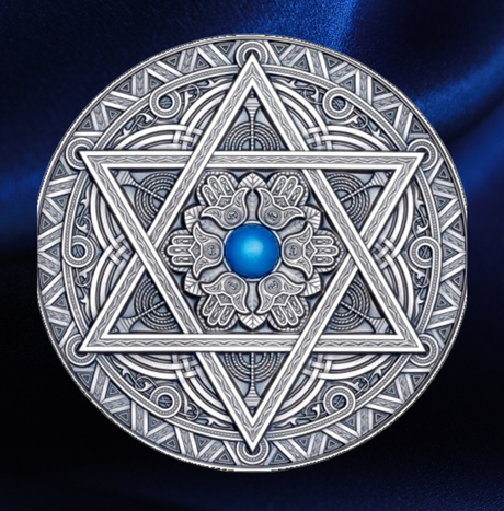 A detailed silver coin with a mandala design featuring a central blue gemstone, surrounding by intricate geometric patterns and the star of David. A luxurious Blue satin Fabric is draped behind the image.
