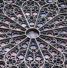 Detail of a colorful mandala art design featuring intricate patterns and the Notre-Dame cathedral iconic rose window reproduction.