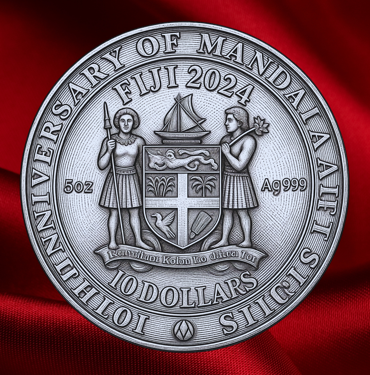 A round silver-toned commemorative coin featuring the words 'Fiji 2024' and '10 Dollars' around a central shield and two human figures, shown against a draped red fabric background.