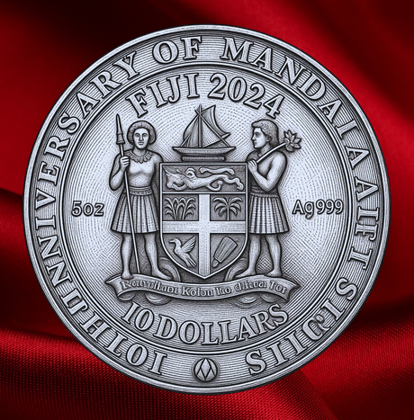 A round silver-toned commemorative coin featuring the words 'Fiji 2024' and '10 Dollars' around a central shield and two human figures, shown against a draped red fabric background.
