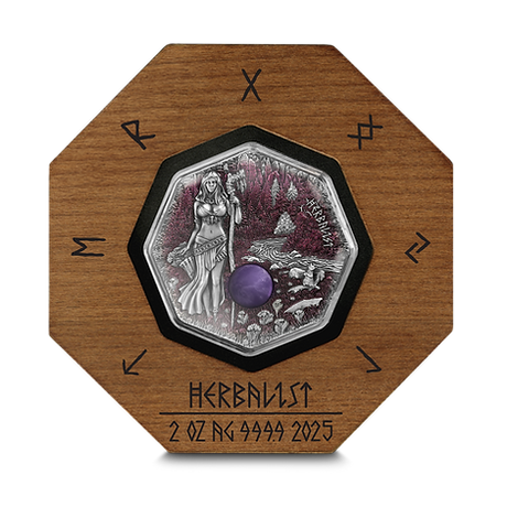 Silver coin with a wooden frame featuring engraved designs and text.