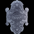 Decorative silver stacker shield with intricate designs on a black background