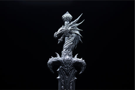 Close-up of the Sword of Chiwoo dragon-headed hilt, showing sweeping horns, intricate ornament and KOMSCO lettering.
