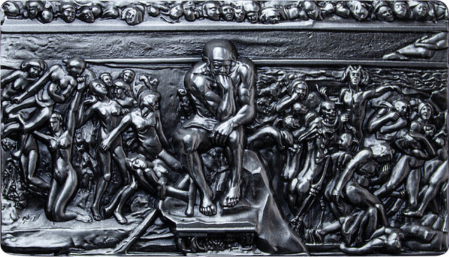 A relief sculpture in Silver depicting 'The Thinker' by Francois Auguste Rene Rodin, made of silver. The Thinker 2oz .999 silver stacker, showing the seated figure surrounded by sculpted figures across a rectangular design.