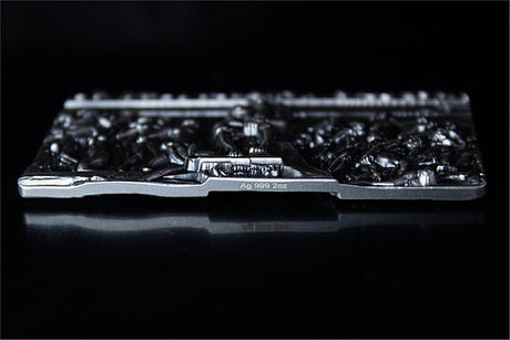 Low-angle view of The Thinker silver stacker, showing its raised relief and Ag 999 2oz edge inscription.