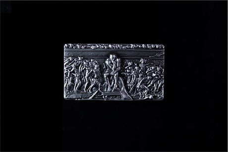 Full view of The Thinker rectangular silver stacker against a black background.