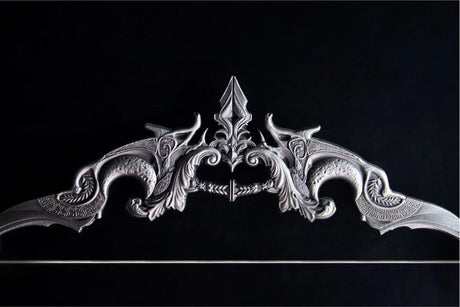 Decorative metal bow with intricate designs on a black background