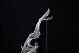 Decorative silver weapon handle on a black background