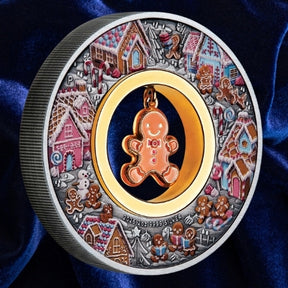 Australia 2026 Gingerbread Christmas silver coin, featuring a coloured gingerbread village and dangling enamelled gingerbread man in its open centre.