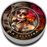 A round silver tin with a colorful Day of the Dead themed label reading 'LA CALAVERA' and 'PLATA PURA'. The label features a sugar-skull woman, roses, and decorative artwork, photographed on a plain white background.