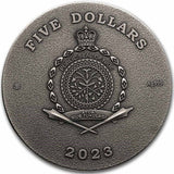 A close-up view of the all-silver obverse face of the 2023 Niue $5 "Lady Flame" coin. The coin is finished in a weathered, antiqued silver style with no colour. Placed in the dead center is the official Public Seal of Niue. The outer ring of the coin is densely filled with crisply engraved ancient Egyptian hieroglyphic symbols, forming a framing pattern around the legal tender inscriptions.