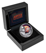 Silver coin with space-themed design in a black display case