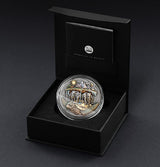 Presentation Case: Akupara silver coin in a capsule inside an open black presentation case.