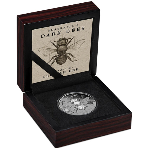 Presentation case: Lucifer Bee silver coin in an open presentation case with Australia’s Dark Bees specimen artwork inside the lid.