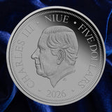 Obverse: Niue 2026 five-dollar Lucifer Bee coin showing the portrait of King Charles III on blue satin.