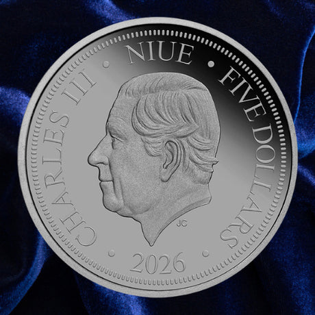 Obverse: Niue 2026 five-dollar Lucifer Bee coin showing the portrait of King Charles III on blue satin.