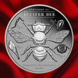 Reverse, red background: 2026 Lucifer Bee 2 oz Black Proof silver coin showing the bee, anatomical studies and Specimen 01 inscription on red satin.