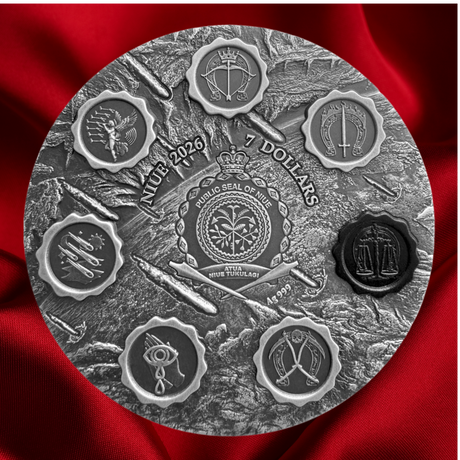 A circular silver-toned commemorative coin or medallion with embossed military-style insignia and text reading 'NIP 2026 7 DOLLARS' and 'WILHO SEAL OF THE ARMY 2026 QUEENSLANDER 1983.' It is photographed against a rich red satin fabric background.