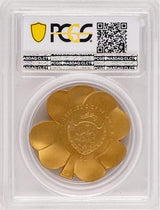 Palau coat of arms on the gold-plated Gilded Fortune clover coin, viewed through the back of its PCGS holder.