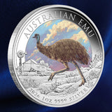 Reverse: 2026 Australian Emu coloured silver coin showing an emu running through the outback, with a windmill and shed, against a blue background.
