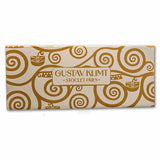 A rectangular package of Gustav Klimt Stoclet Fries, featuring a cream-colored background with a gold abstract swirl pattern and a central label with the brand name.