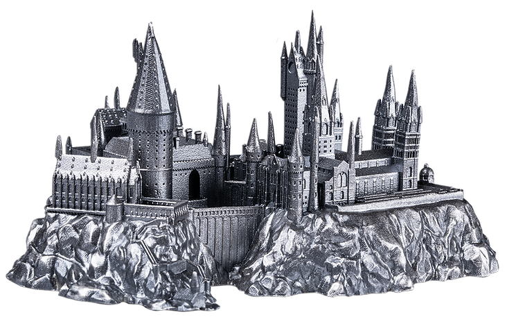 Metallic model of a castle on a rocky base with a white background
