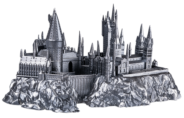 Metallic model of a castle on a rocky base with a white background
