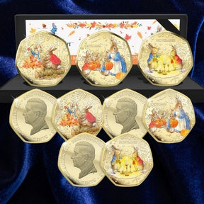 Peter Rabbit Tales of Autumn three-coin set with presentation case, coloured reverses and King Charles III obverses on blue satin.