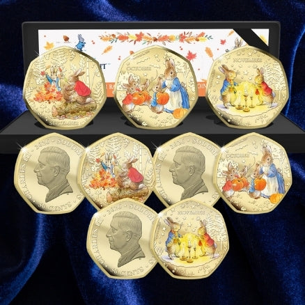 Peter Rabbit Tales of Autumn three-coin set with presentation case, coloured reverses and King Charles III obverses on blue satin.