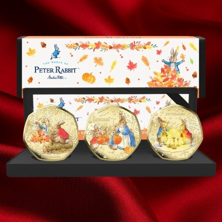 Peter Rabbit Tales of Autumn September, October and November coins in a presentation case with illustrated packaging on red satin.