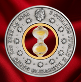 A round silver commemorative coin featuring a central clear glass hourglass filled with gold sand, set against a red fabric background. The coin is inscribed with '2 DOLLARS TUVALU II QUEEN ELIZABETH II 9999 Ag 2021' and features a profile of Queen Elizabeth at the top.
