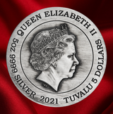 A round silver-colored commemorative coin or medallion featuring a profile portrait of Queen Elizabeth II, with engraved text reading 'QUEEN ELIZABETH II', '5 DOLLARS', 'SILVER', and '2021 TUVALU'. The coin is centered against a rich red fabric background.