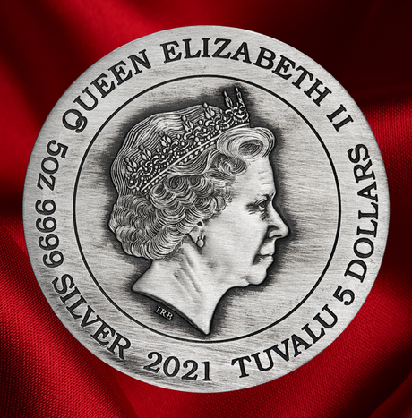 A round silver-colored commemorative coin or medallion featuring a profile portrait of Queen Elizabeth II, with engraved text reading 'QUEEN ELIZABETH II', '5 DOLLARS', 'SILVER', and '2021 TUVALU'. The coin is centered against a rich red fabric background.