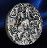 An oval silver-toned relief medallion featuring a detailed historical battle scene with a warrior on horseback holding a spear, set against a dark blue satin background.