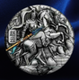 A circular silver-toned relief medallion featuring a detailed equestrian warrior scene with a Chinese character on the left, set against a dark blue satin-like background.