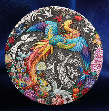 A round decorative plate featuring a highly detailed, colorful illustration of a phoenix and other birds amidst flowers, set against a dark blue fabric background.