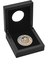 Decorative coin in a black display box on a white background