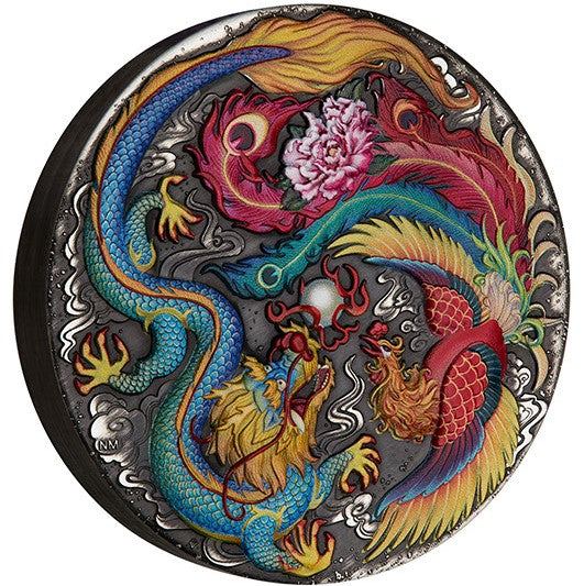 Tuvalu 2024 $5 Dragon and Phoenix 5oz .9999 Silver Antique Coloured Coin Reverse side view showing smooth rim. The coin is a round silver-toned metal medallion featuring a detailed relief design of a blue dragon and a red phoenix surrounding a pink peony, set against a dark blue satin background.