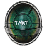 Circular object with green center and metallic rim, featuring 'TMNT' text.