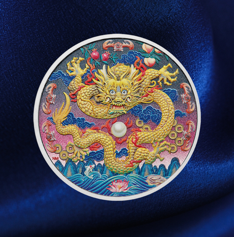 A circular embroidered dragon ornament featuring a golden dragon with red and blue details, displayed on a dark blue satin fabric background.