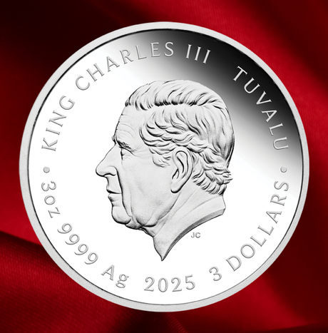 A round silver coin featuring a profile portrait of King Charles III of Tuvalu, with engraved text reading 'KING CHARLES III TUVALU' and '3 DOLLARS 9999 Ag 2025'. The coin is photographed against a rich red fabric background.