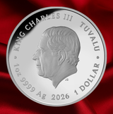 A round silver coin featuring a profile portrait of King Charles III of Tuvalu, with engraved text reading 'KING CHARLES III TUVALU', '1 OZ 9999 Ag', and '2026 1 DOLLAR'. The coin is photographed against a rich red satin fabric background.  - FORTYMILLION