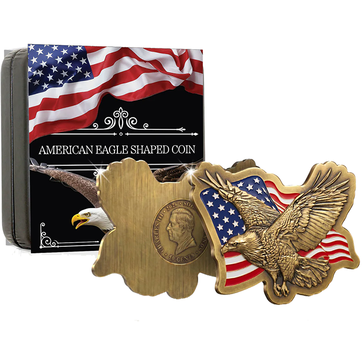 An American eagle shaped commemorative coin shown in front of its retail box. The coin has a gold-toned finish with a profile portrait on one side and an eagle over an American flag design on the other.